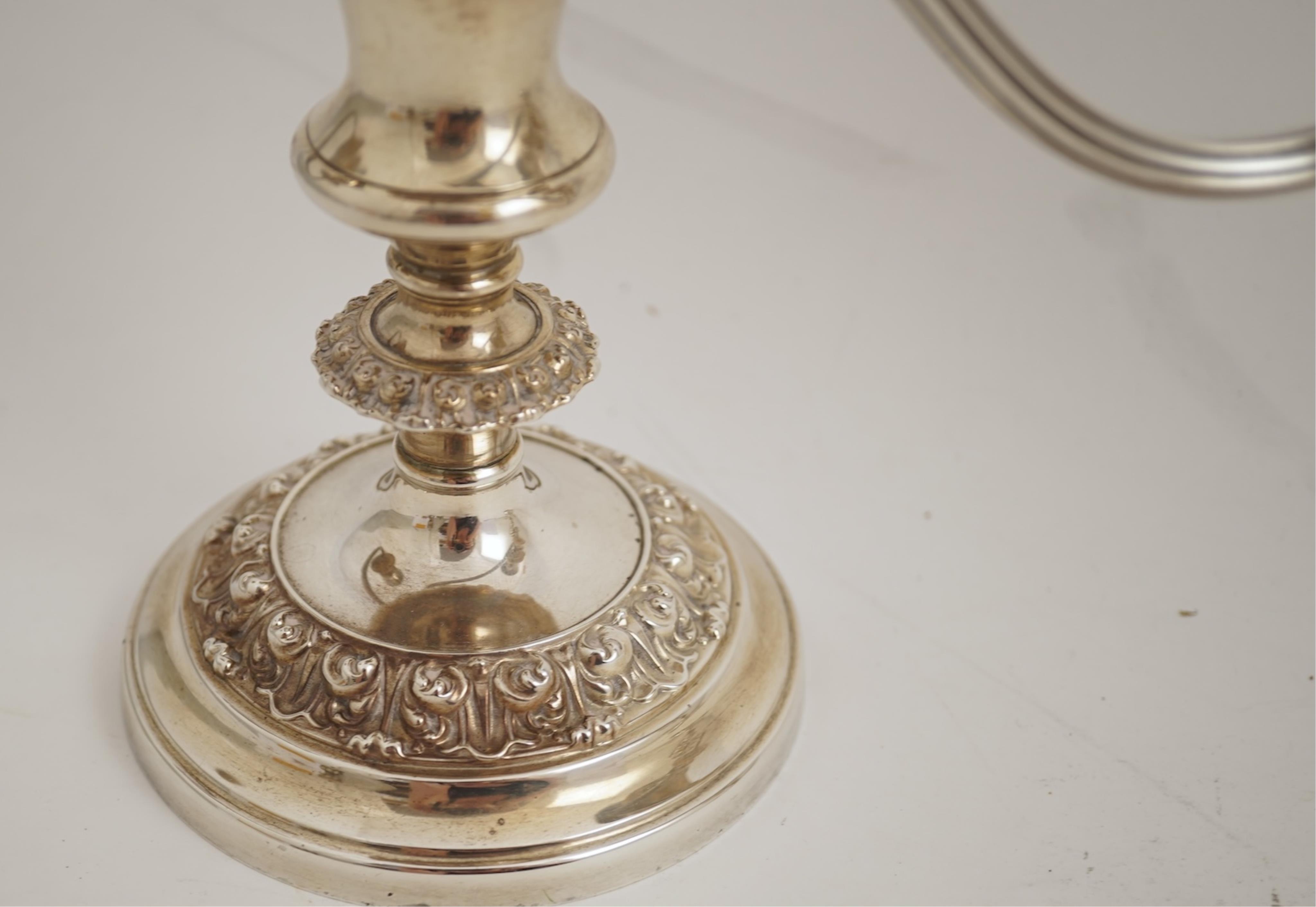 A pair of Elizabeth II silver dwarf two branch, three light candelabra by Barker Brothers Silver Co, with scroll arms and turned knopped stems, Birmingham, 1960, weighted, arms 52oz.